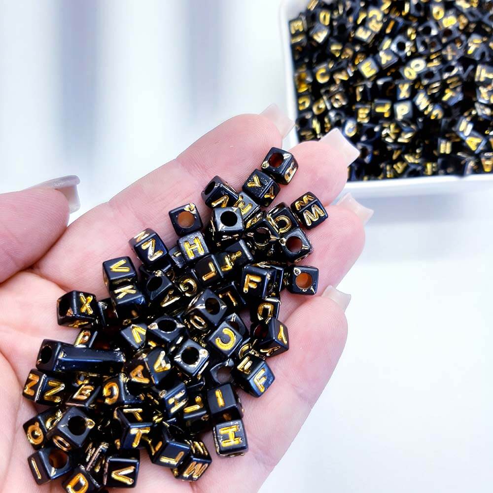 letra-quadrada-preta-com-dourado.jpg Miçanga Letrinha Alfabeto Dadinho Preto 6x6mm- 50 gramas - Imagem 1